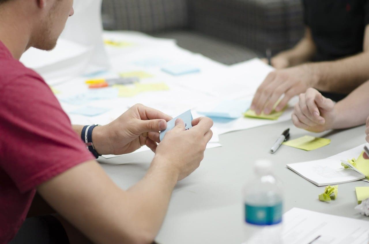 Team members sorting sticky notes during a planning workshop